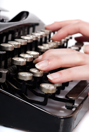 fingers on vintage typing machine on white